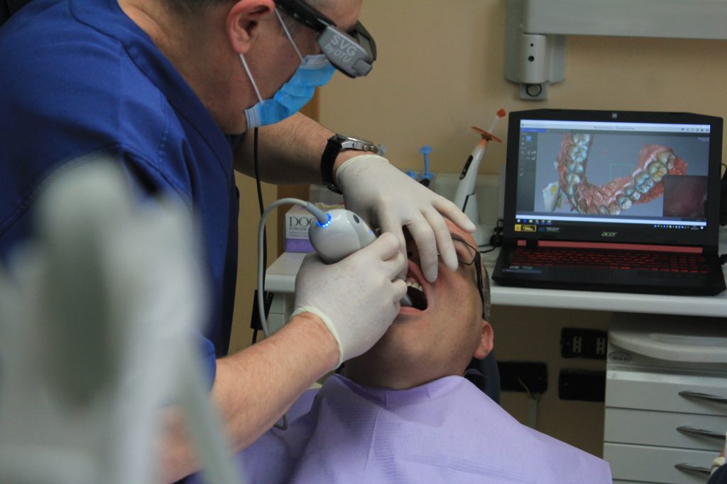 orthodontist helping patient
